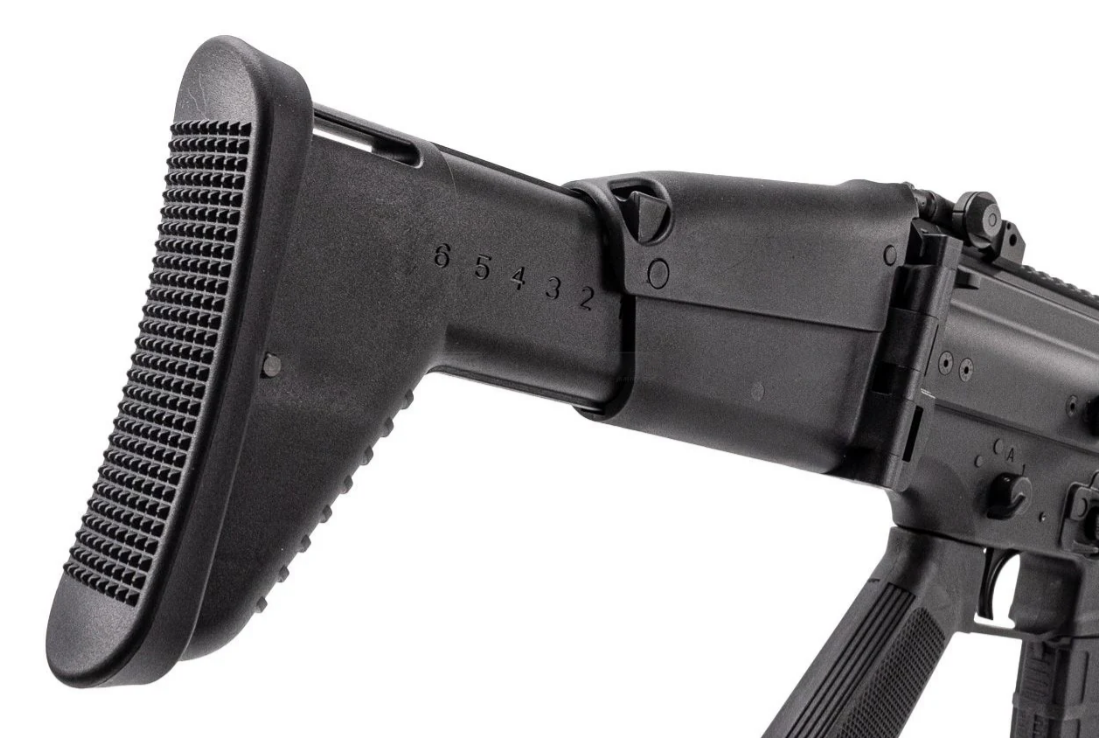 Close-up of a black rifle with a textured stock